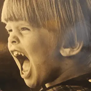 Old photograph of a 5-year-old Tim. He is yelling.